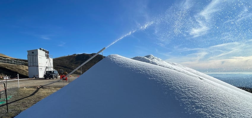 Huge pile of manmade snow at Spurs with Mt Buller summit in the background