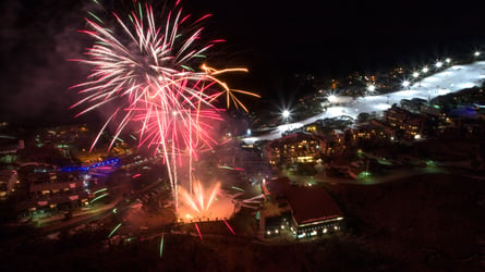 Fireworks light the sky above Mt Buller with night skiing and lights on Bourke Street